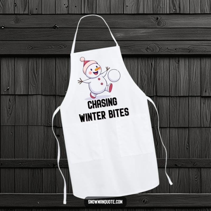 Funny snowman chase apron depicting a winter character enthusiastically chasing a bouncing snowball, designed for kitchen use with humorous winter play flair.