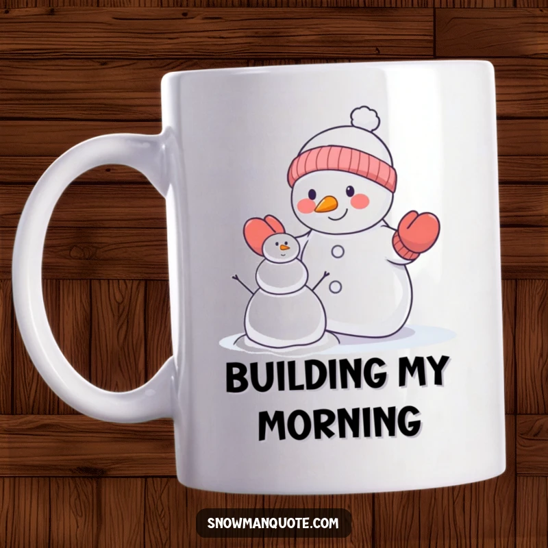 Funny snowman mug showing a snowman in mittens trying to build a smaller snowman, capturing a comical winter effort.