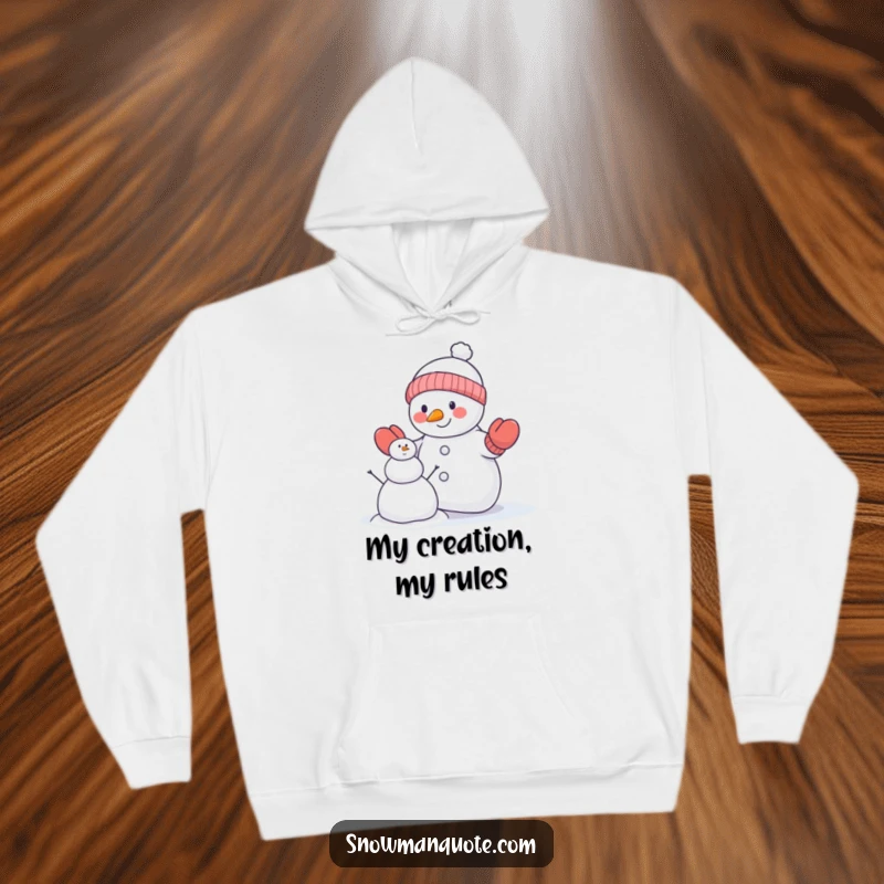 Funny snowman hoodie depicting a snowman in mittens attempting to build a smaller snowman, offering warmth and humorous winter vibes.