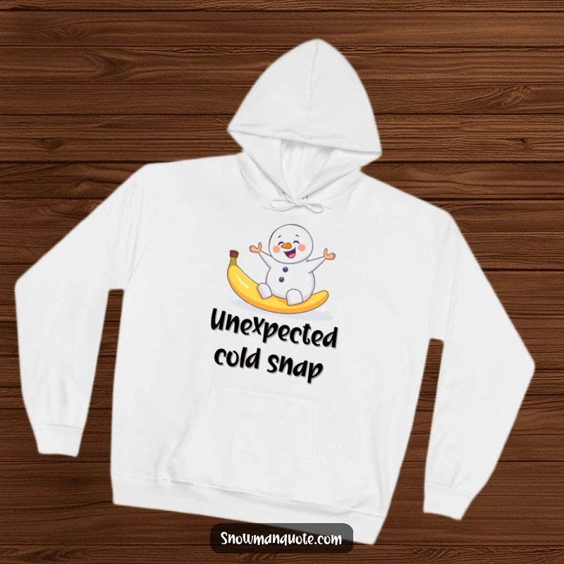 Funny hoodie depicting a snowman comically slipping backwards on a discarded banana peel, arms windmilling.