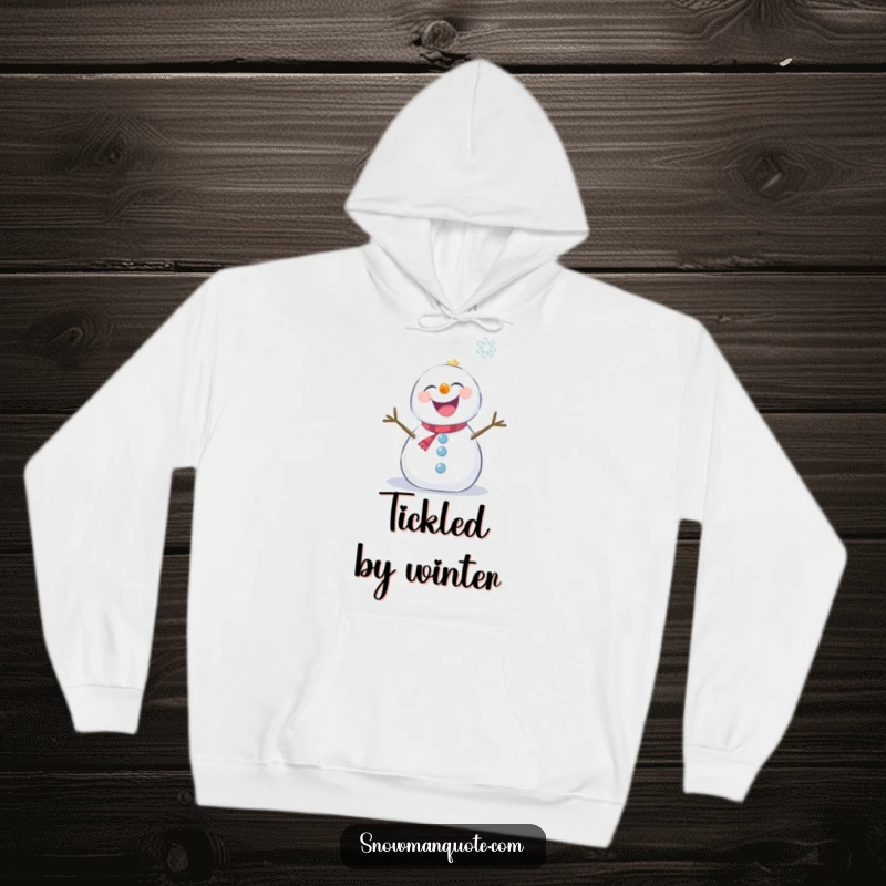 Funny snowman giggling with delight while a snowflake tickles it, printed on a warm hoodie.