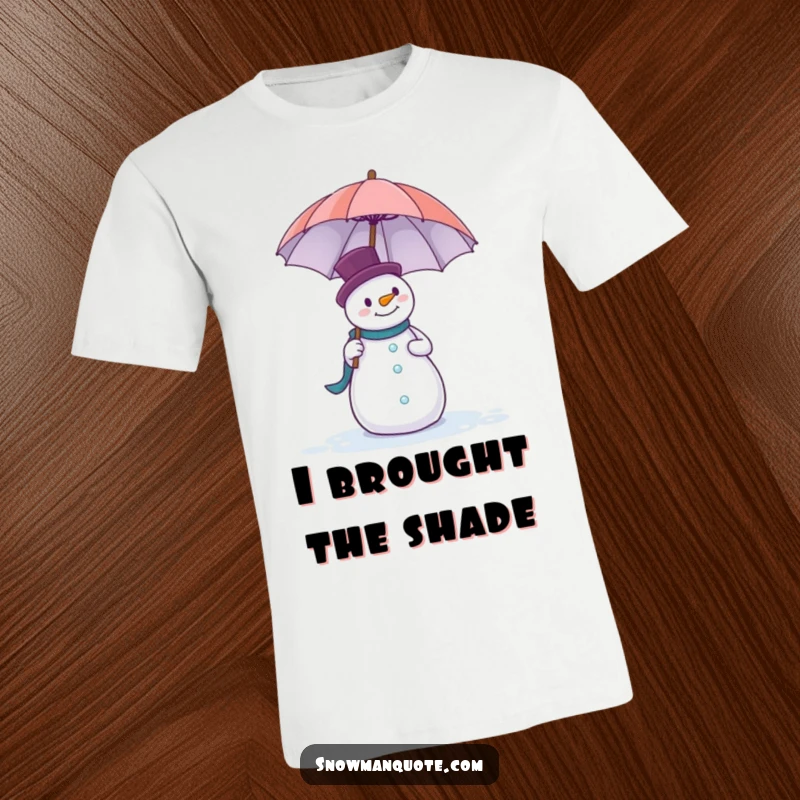 Funny t-shirt with a clumsy snowman hilariously trying to keep a large umbrella from flying away in the wind.